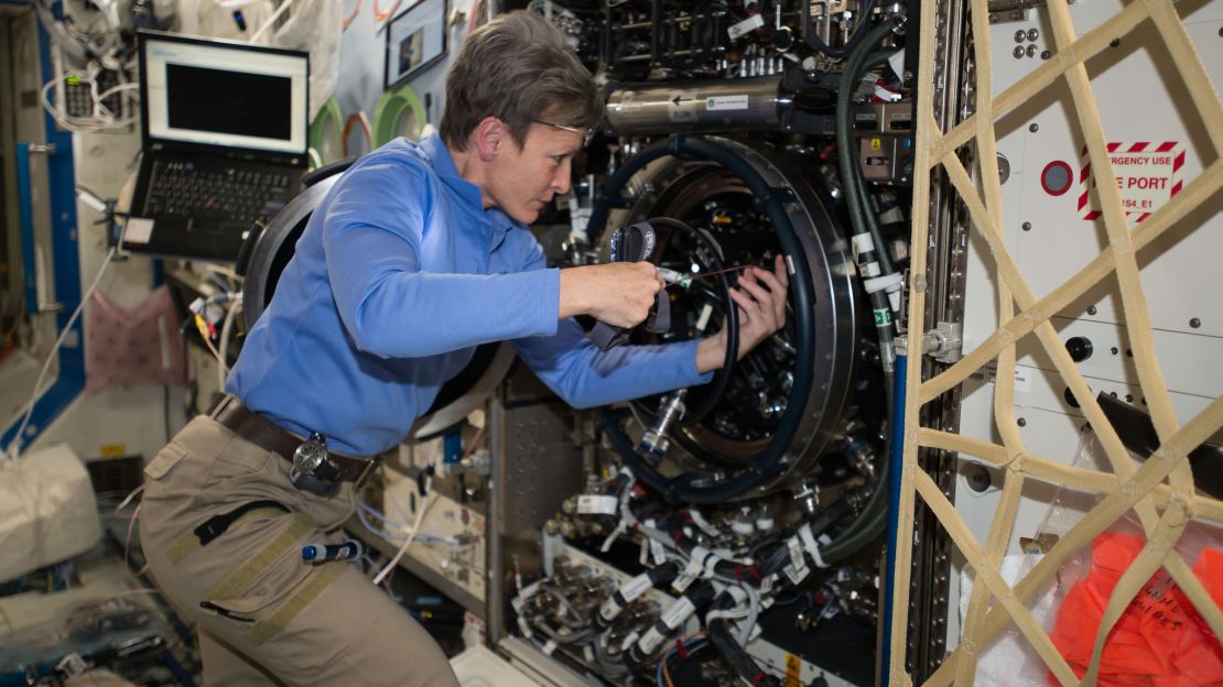 NASA astronaut and space station commander Peggy Whitson does some troubleshooting on the space station in December 2016.