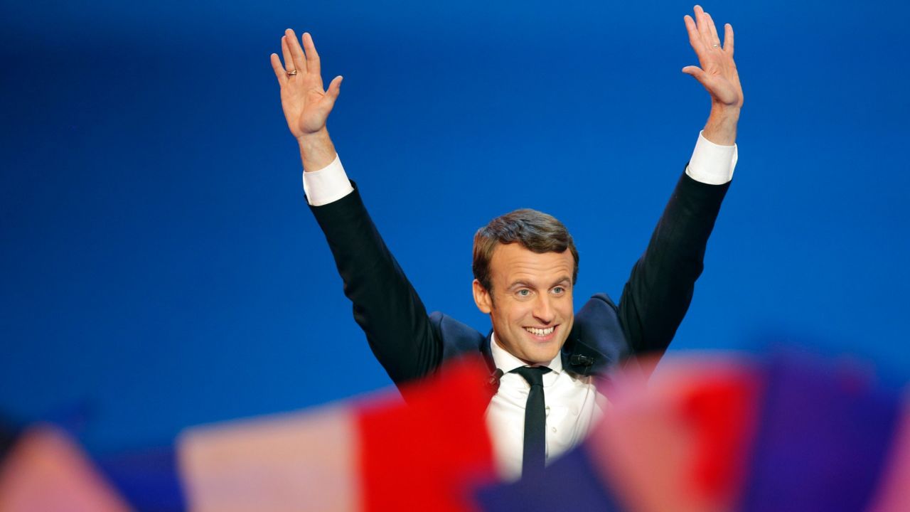 Macron, a pro-European centrist, waves before addressing supporters in Paris on April 23. With 97% of polling stations declared, Macron was in first place with 23.9% of the vote. Le Pen had 21.4%.