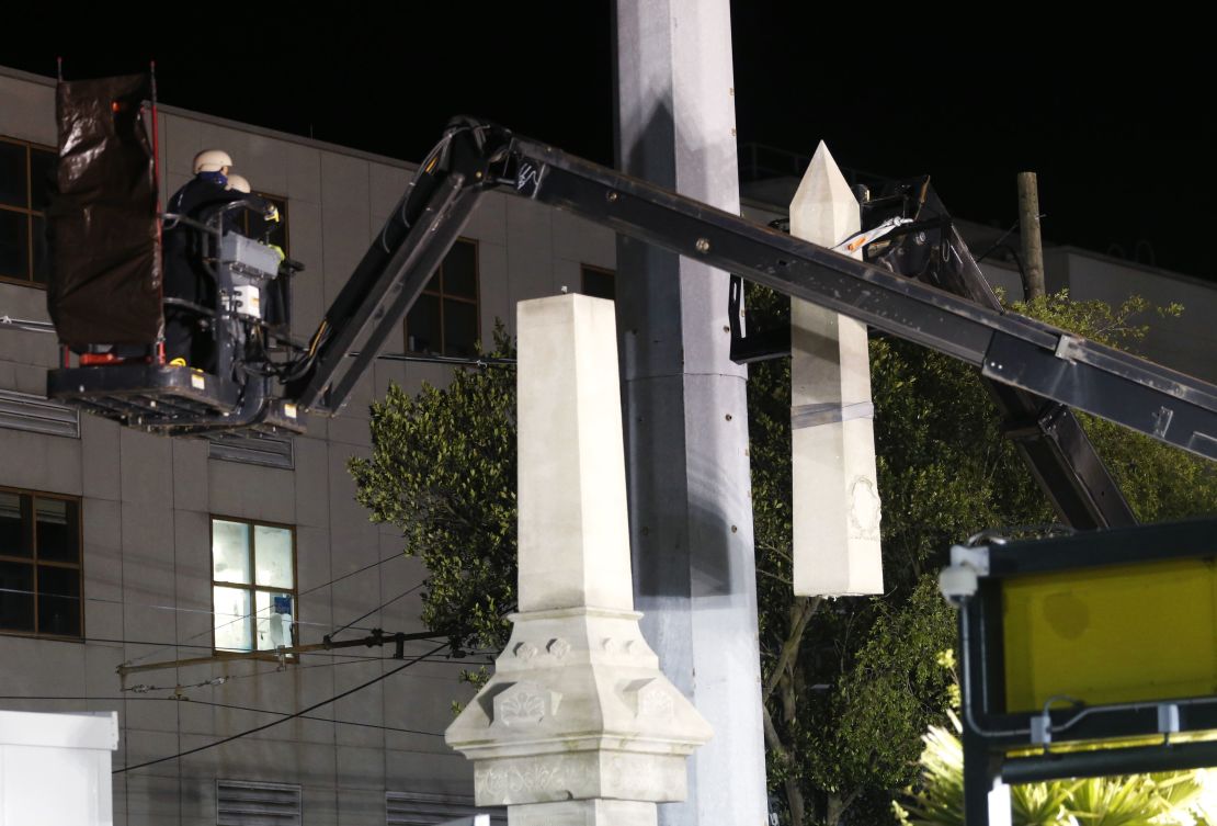 Workers use a crane to dismantle the Battle of Liberty Place monument early Monday morning.