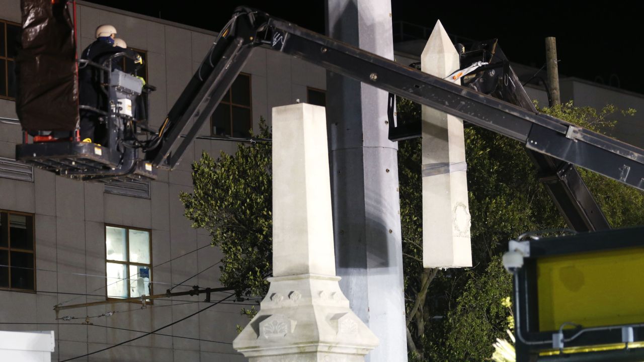 Workers dismantle the Liberty Place monument Monday, April 24, 2017, which commemorates whites who tried to topple a biracial post-Civil War government, in New Orleans. It was removed overnight in an attempt to avoid disruption from supporters who want the monuments to stay. (AP Photo/Gerald Herbert)