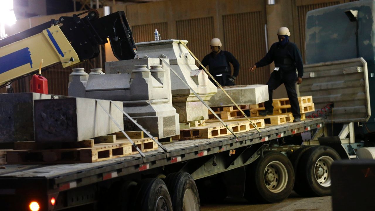 Masked workers dismantle the Battle of Liberty Place monument in New Orleans on April 24.