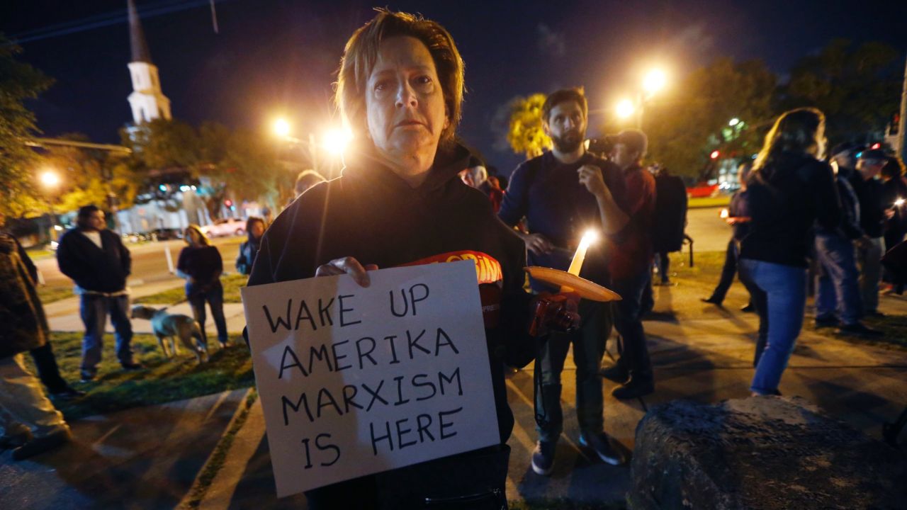 Dana Farley of New Orleans joins a candlelight vigil April 24 at the statue of Jefferson Davis.
