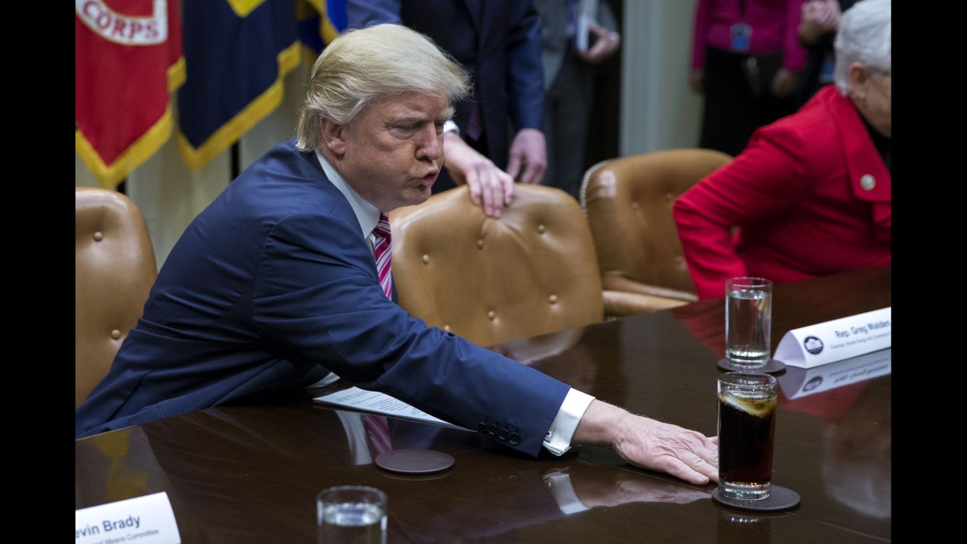 Trump moves a drink across the table before a White House discussion about health care on Friday, March 10. The President's habit of moving things caught the eye of CNN's Jeanne Moos, <a href="http://www.cnn.com/videos/politics/2017/03/31/trump-moves-things-habit-pyschology-moos-dnt-erin.cnn" target="_blank">who reported on the unusual quirk.</a>