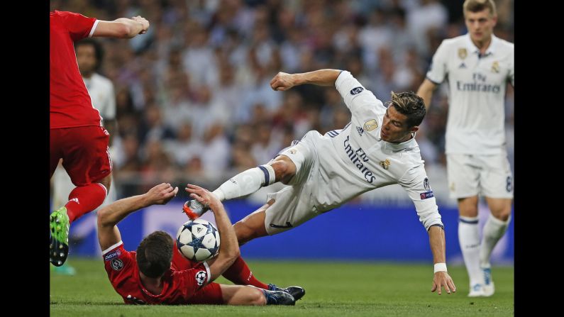 Real Madrid star Cristiano Ronaldo, right, competes for the ball with Bayern Munich's Xabi Alonso during a Champions League quarterfinal match on Tuesday, April 18. Ronaldo scored a hat trick in Madrid's 4-2 victory.