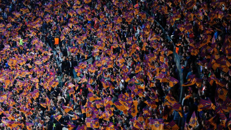 Supporters of FC Barcelona wave flags before their Champions League quarterfinal match against Juventus on Wednesday, April 19.