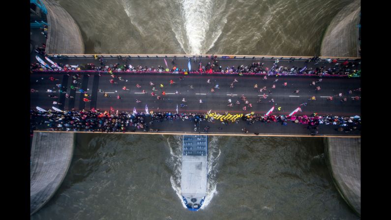 Runners cross the Tower Bridge during the halfway point of the London Marathon on Sunday, April 23.