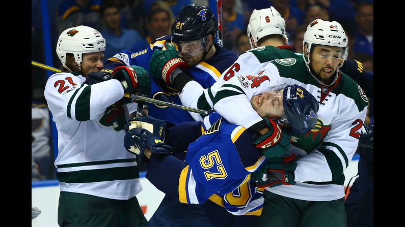 Minnesota's Matt Dumba puts St. Louis' David Perron in a headlock during an NHL playoff game on Wednesday, April 19. 