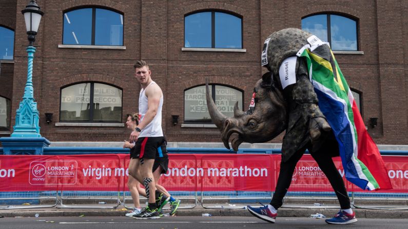 A runner dressed as a rhino takes part in the London Marathon on Sunday, April 23.