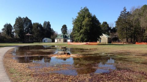 Water covers graves after a rainfall before the rehabilitaton project began in late 2015.