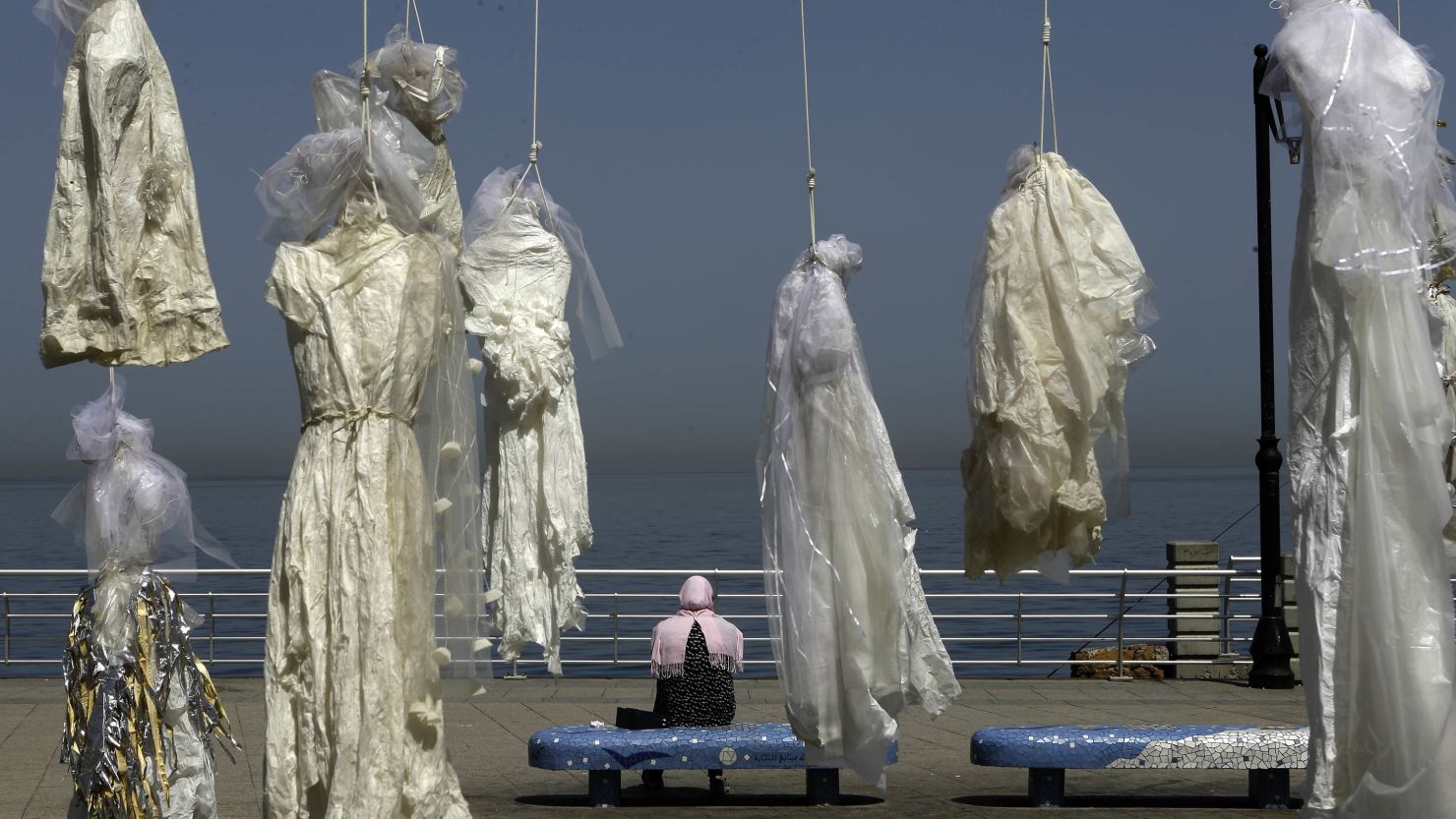 Wedding dresses hang from nooses in Beirut during a protest against marriage rape laws.