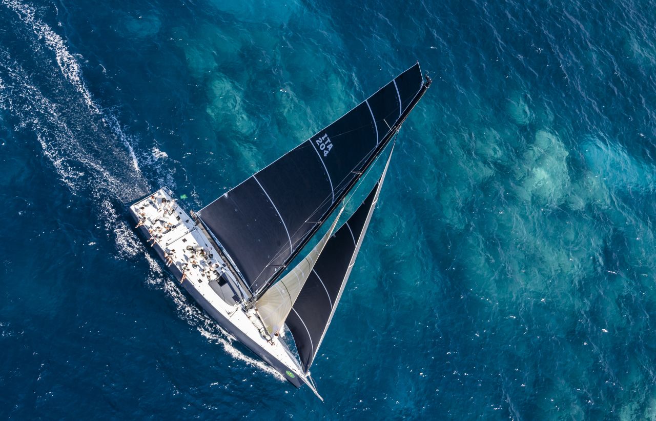 The Farr 70 Atalanta II skirts a shallow reef on a glamor day for sailing. 