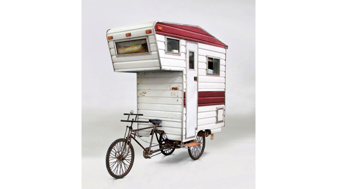 Perched on a tricycle and constructed from corrugated aluminum, plexiglas, plywood and timber, this pedal-powered concept mobile home is large enough for one person. 