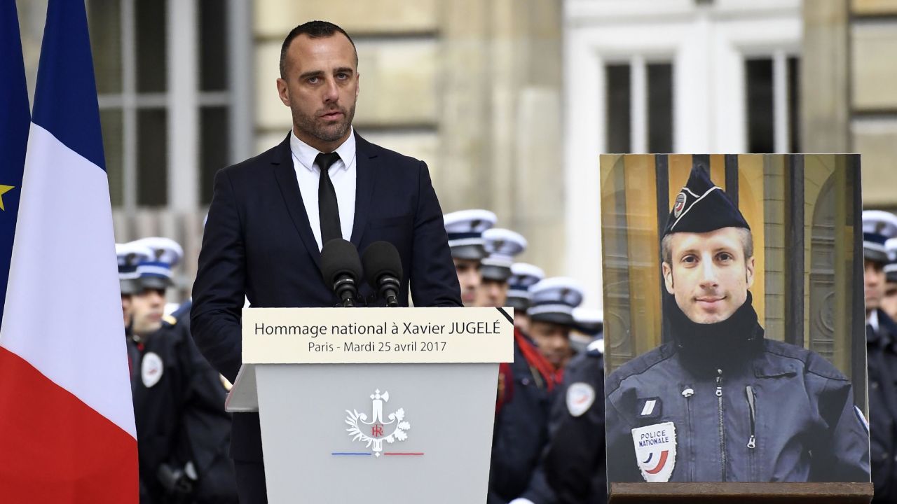 Etienne Cardiles, the partner of Xavier Jugele, the policeman (portrait) killed by a jihadist in an attack on the Champs Elysees, gives a speech during a ceremony to pay tribute to him on April 25, 2017 at the Paris prefecture building.
French police officer Xavier Jugele was killed on the world-famous Paris avenue on April 20, in an attack claimed by the Islamic State group. / AFP PHOTO / Bertrand GUAY        (Photo credit should read BERTRAND GUAY/AFP/Getty Images)