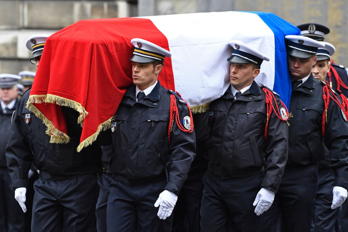 French police officers carry Jugelé's flag-draped casket.