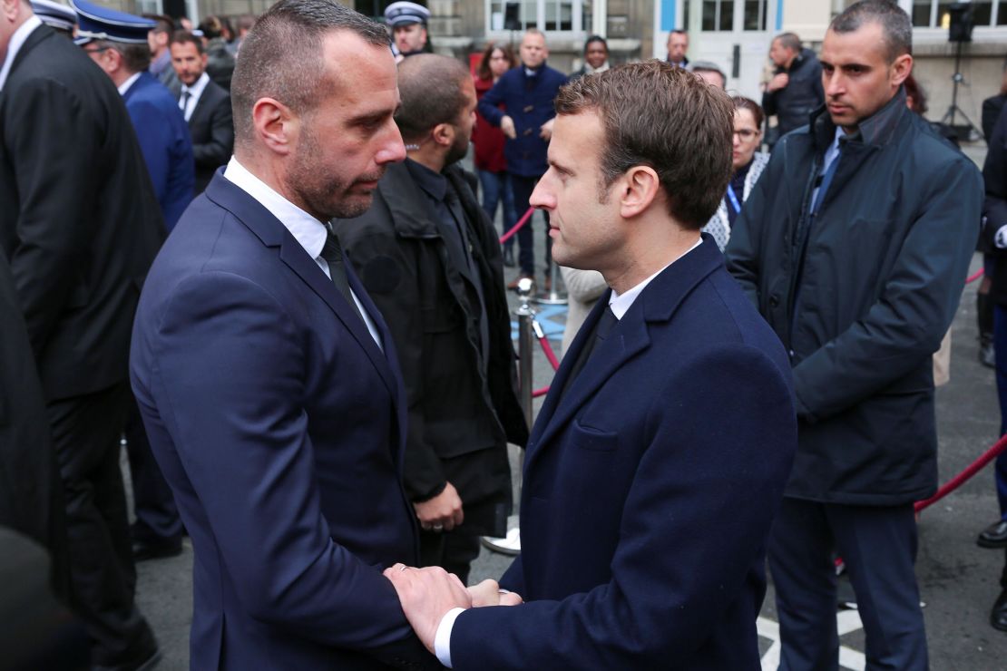 French presidential candidate Emmanuel Macron shakes hands with Jugelé's partner.