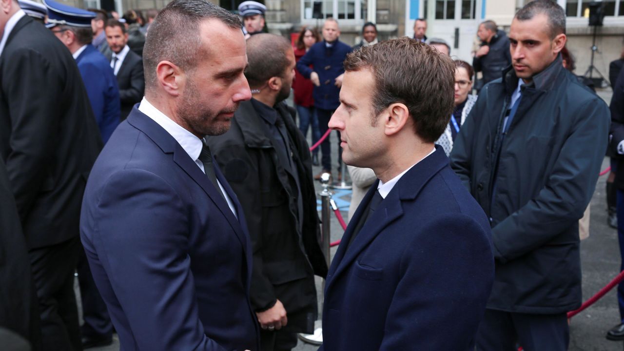 Cardiles (L) shakes hands with then-candidate Emmanuel Macron at a ceremony for Jugelé in April. 