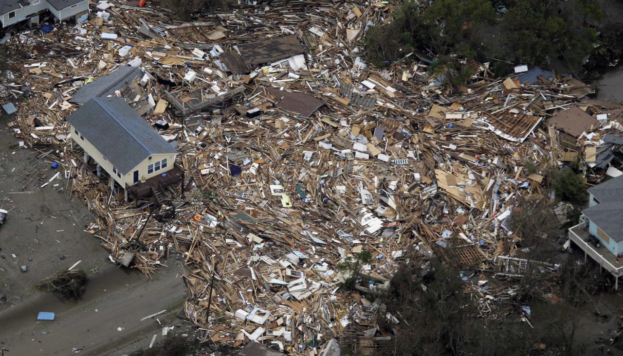 Houses sit amid debris on September 14, 2008, in Crystal Beach, Texas, after Hurricane Ike swept through the area.  