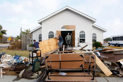 Workers remove debris on September 21, 2008, from Monte Calvario Pentecostal Church in Galveston, Texas, after it was damaged by a flood from Hurricane Ike.
