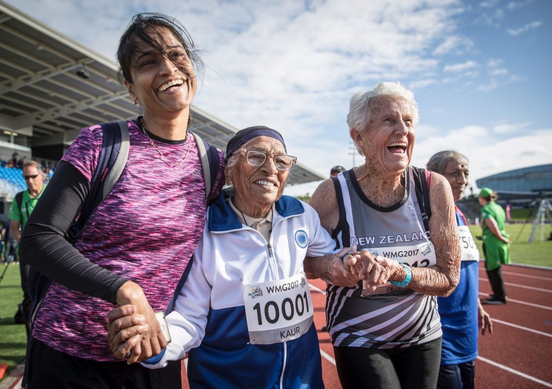 Centenarian Man Kaur, 101, and her admirers celebrate her win in the 100m race at the 2017 World Masters Games in Auckland. 