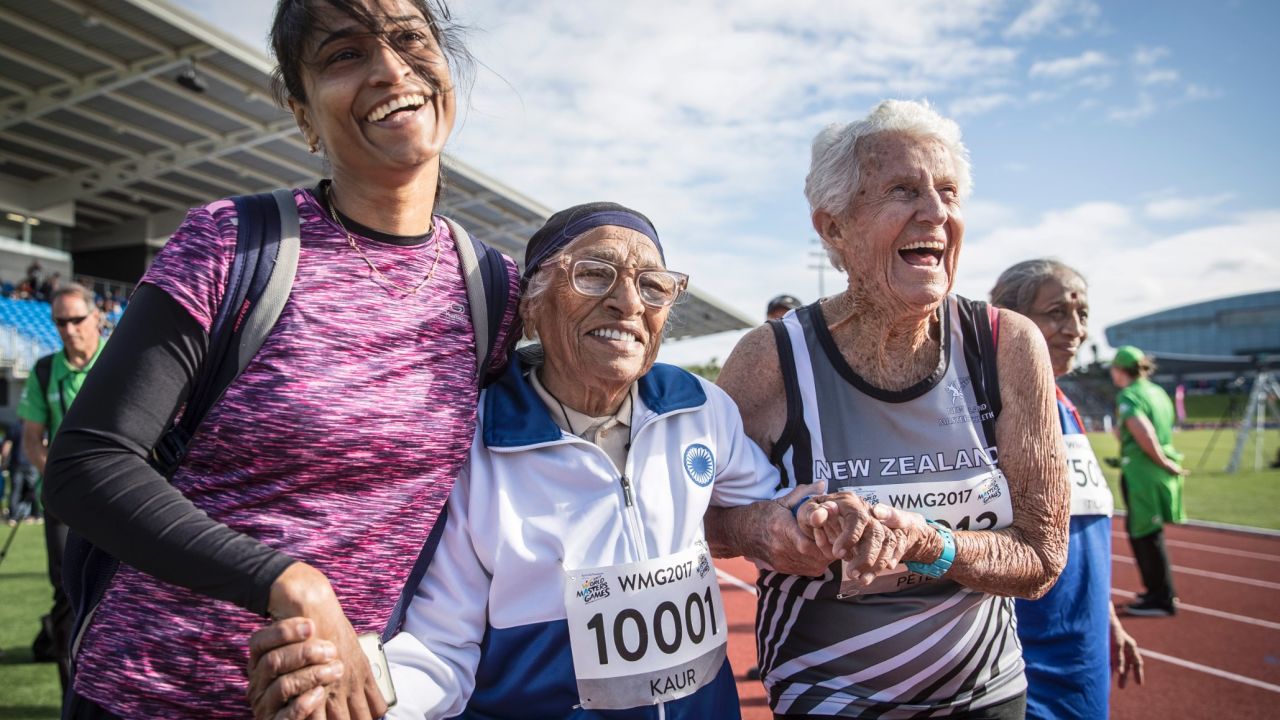 Centenarian Man Kaur, 101, and her admirers celebrate her win in the 100m race at the 2017 World Masters Games in Auckland. 