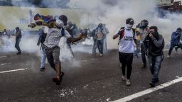 Opposition activists clash with riot police during a protest march in Caracas on April 26, 2017.
Protesters in Venezuela plan a high-risk march against President Maduro Wednesday, sparking fears of fresh violence after demonstrations that have left 26 dead in the crisis-wracked country. / AFP PHOTO / JUAN BARRETO        (Photo credit should read JUAN BARRETO/AFP/Getty Images)