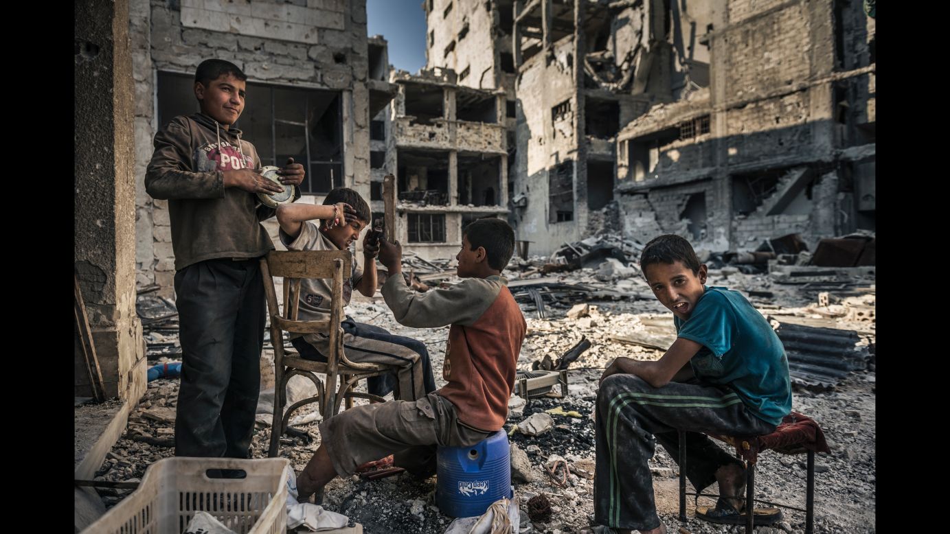 Homeless children play in the ruins of Homs after opposition forces left the area. During the siege, children were left to fend for themselves when their parents went missing or were caught on the wrong side of newly established checkpoints. (June 14, 2014)