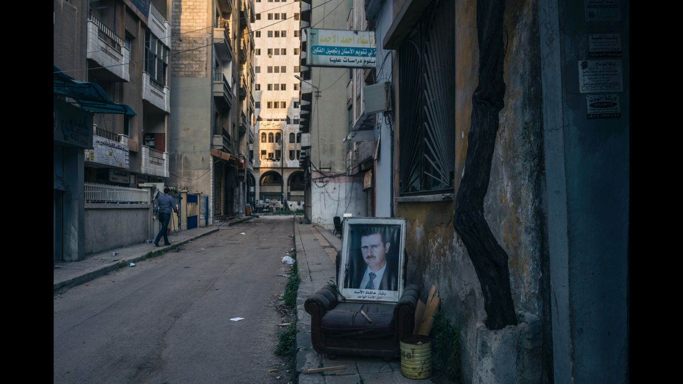 A portrait of the President is displayed on a chair in the government-controlled sector of Homs, 40 meters from the sniper-controlled frontline that divided the city. (March 23, 2014)