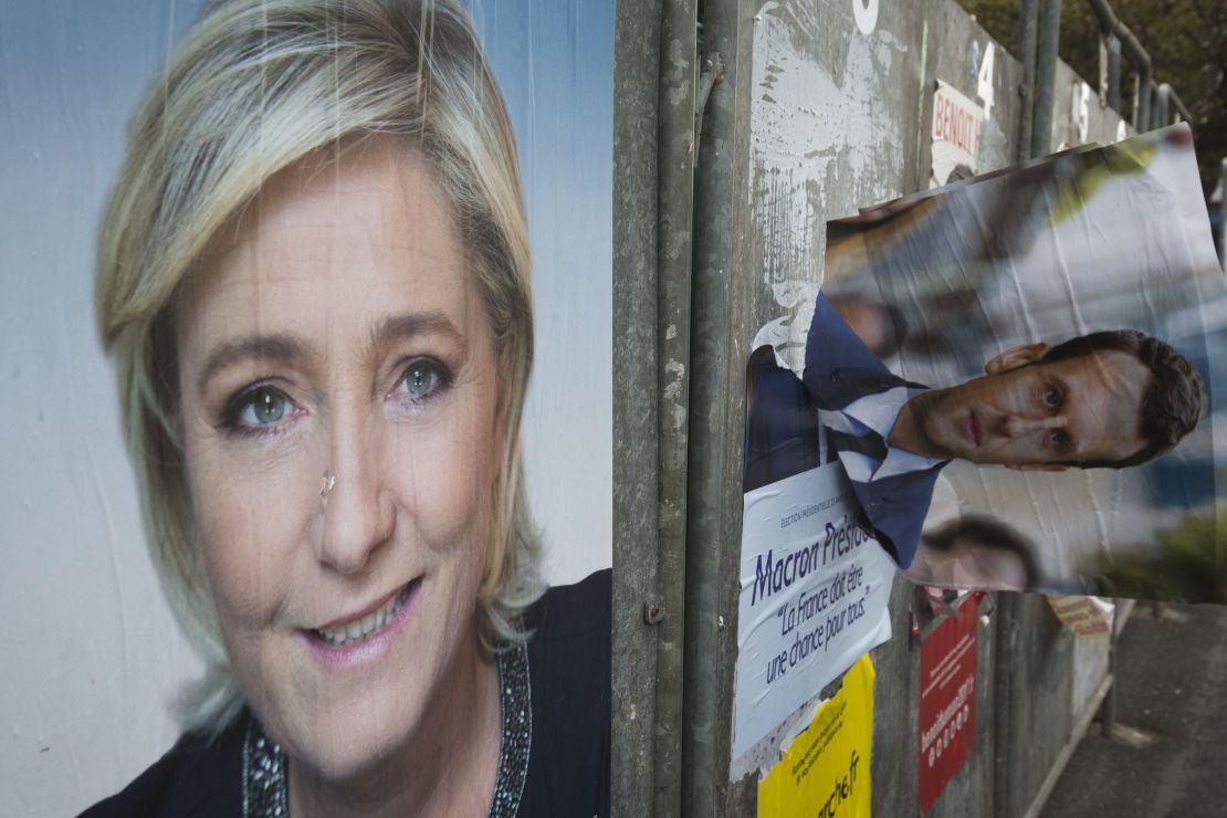 Campaign posters of French presidential election candidates Marine Le Pen and Emmanuel Macron in the Le Pen stronghold of Henin-Beaumont, northern France.