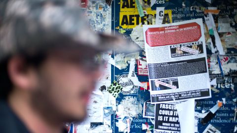 UC Berkeley graduate student Jacob Slater-Chin, 24, reads an "anti-fascist" flyer denouncing Coulter's planned visit to campus. He says he's bothered she won't be speaking.