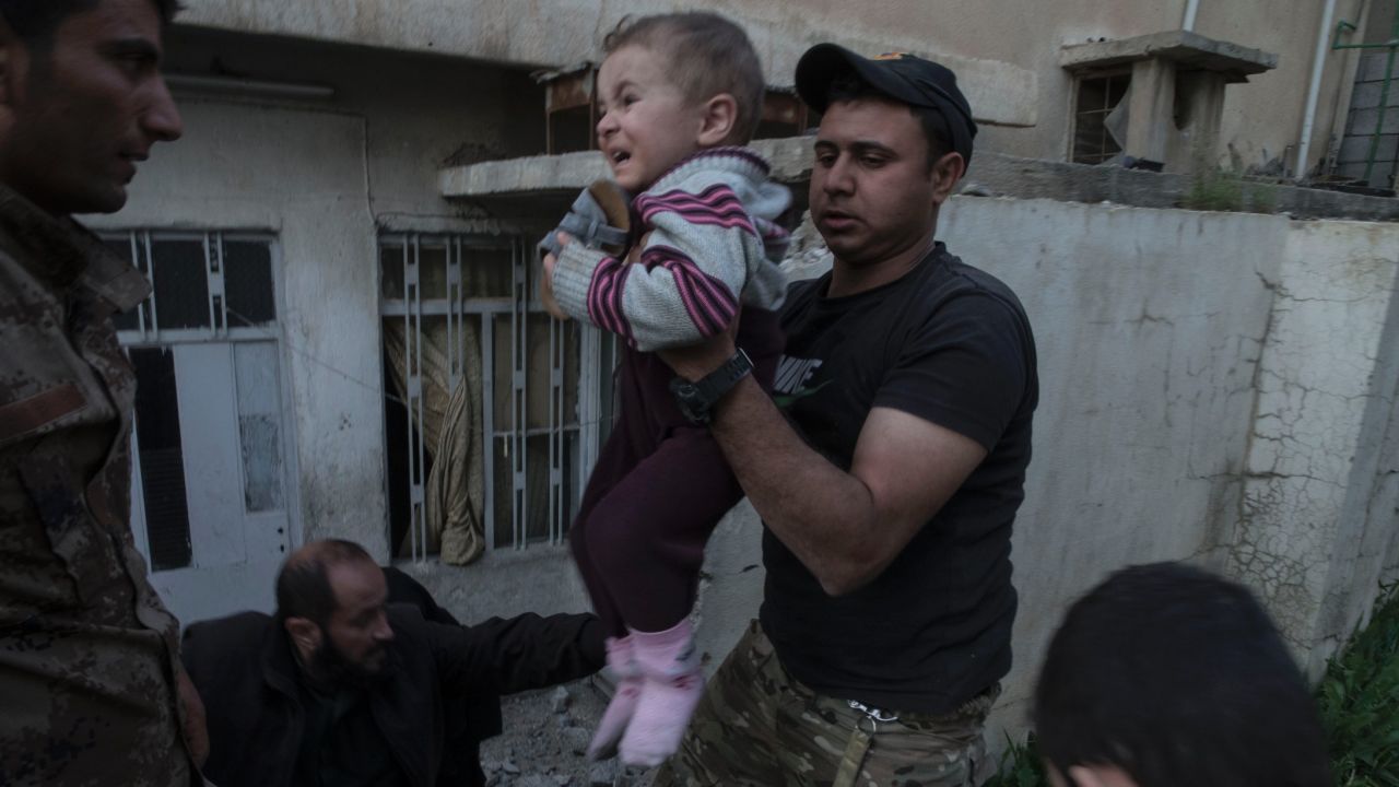 Iraqi special forces assist civilians out of their homes as heavy clashes between Iraq special forces and ISIS raged on in west Mosul's al Yarmouk neighborhood on April 9.