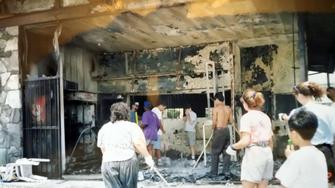 Chang Lee's neighbors came out to help him clean up after his gas station burned down.