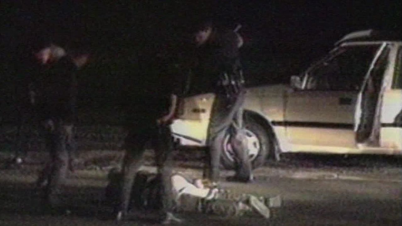 A still image from Holliday's footage shows Rodney King on the ground surrounded by police officers.