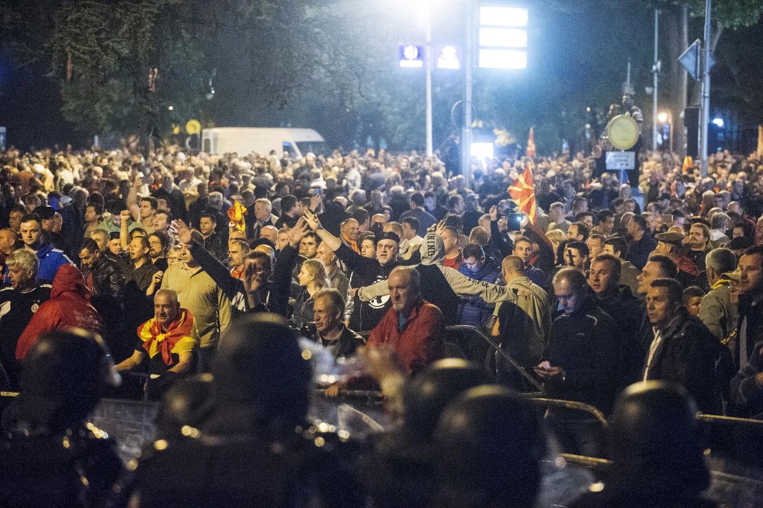 Police face protesters gathered outside Macedonia's parliament in Skopje on April 27.