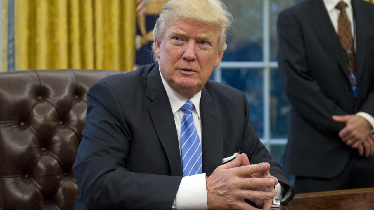 WASHINGTON, DC - JANUARY 23:  (AFP OUT) U.S. President Donald Trump prepares to sign three Executive Orders in the Oval Office of the White House in Washington, DC on Monday, January 23, 2017.  These concerned the withdrawal of the United States from the Trans-Pacific Partnership (TPP), a US Government hiring freeze for all departments but the military, and "Mexico City" which bans federal funding of abortions overseas. (Photo by Ron Sachs - Pool/Getty Images)