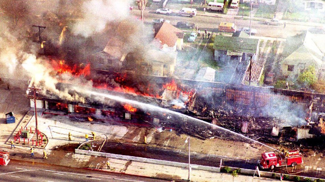 A fire department crew sprays water on a burning mini-mall in south Los Angeles on April 30,1992 after a night of rioting.