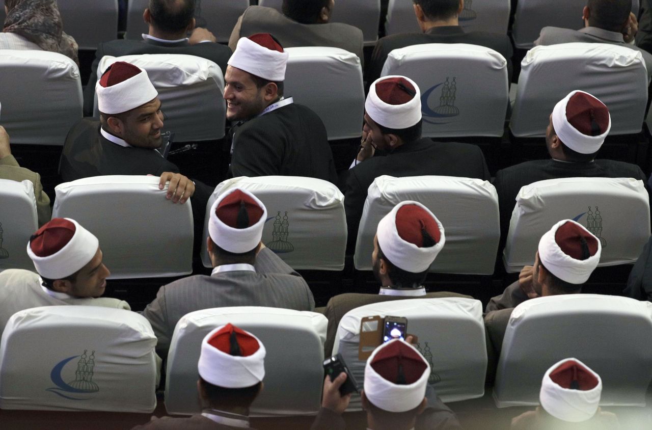 Muslim scholars wait for the peace conference to begin.