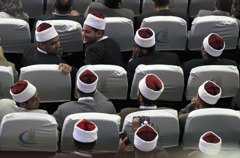 Muslim scholars wait for the peace conference to begin.