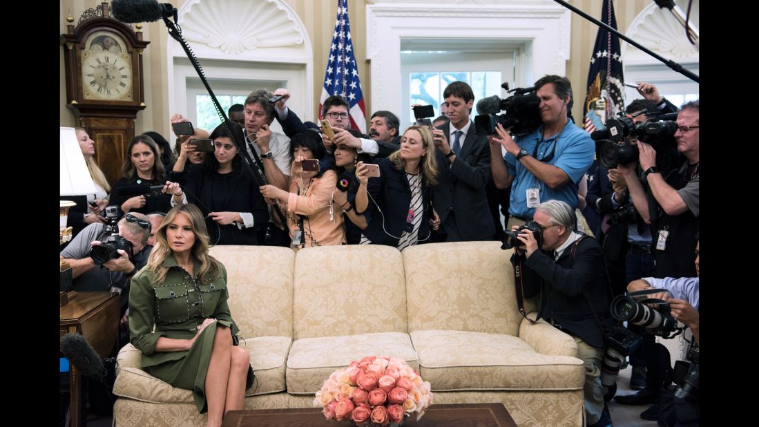 Trump listens while her husband speaks to the press in the White House Oval Office.