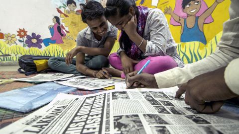 Reporters Deepak and Joti examine an early edition of Balaknama, a newspaper by street children in Delhi. 