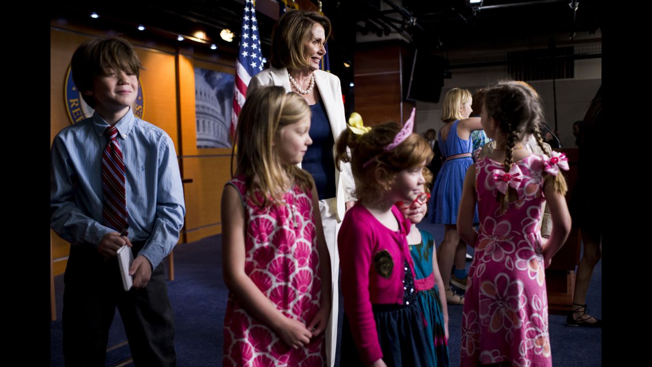 House Minority Leader Nancy Pelosi poses with journalists' children at the end of her weekly news conference in Washington on Thursday, April 27. It was national Take Our Daughters and Sons to Work Day, and many journalists brought their children to the US Capitol.