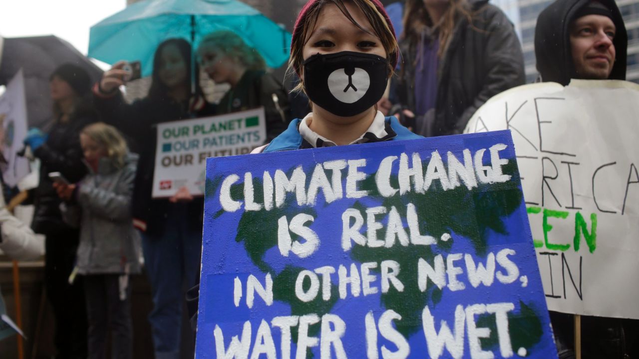 Demonstrators hold signs during a climate march in Chicago.