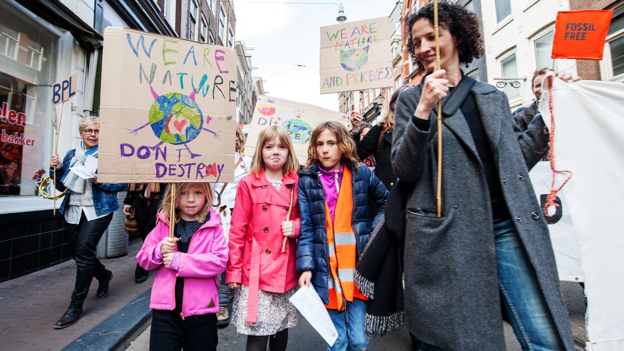 People take part in a climate march in Amsterdam, Netherlands.