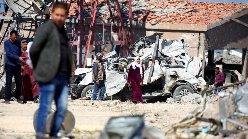 TOPSHOT - Relatives of Kurdish People's Protection Units (YPG) fighters visit the site of Turkish airstrikes near northeastern Syrian Kurdish town of Derik, known as al-Malikiyah in Arabic, on April 25, 2017.
Turkish warplanes killed more than 20 Kurdish fighters in strikes in Syria and Iraq, where the Kurds are key players in the battle against the Islamic State group.
The bombardment near the city of Al-Malikiyah in northeastern Syria saw Turkish planes carry out "dozens of simultaneous air strikes" on YPG positions overnight, including a media centre, the Syrian Observatory for Human Rights said. / AFP PHOTO / DELIL SOULEIMAN        (Photo credit should read DELIL SOULEIMAN/AFP/Getty Images)