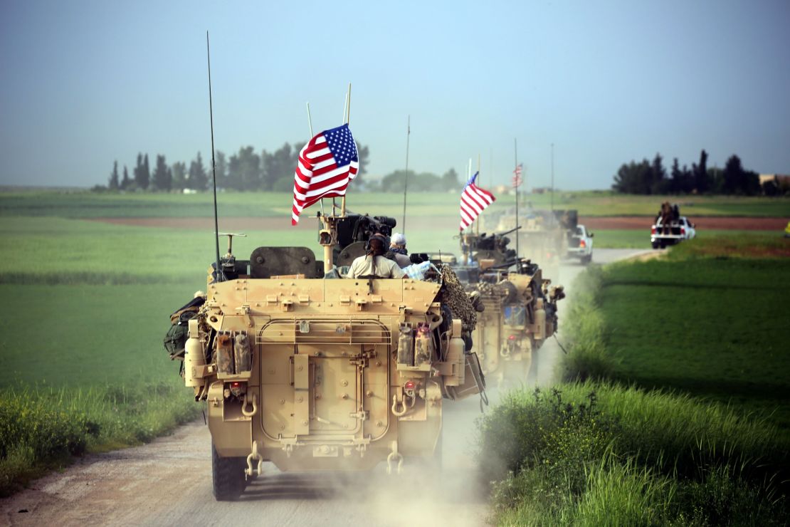 US forces accompanied by the Kurdish People's Protection Units (YPG) near the Syrian border with Turkey in April.