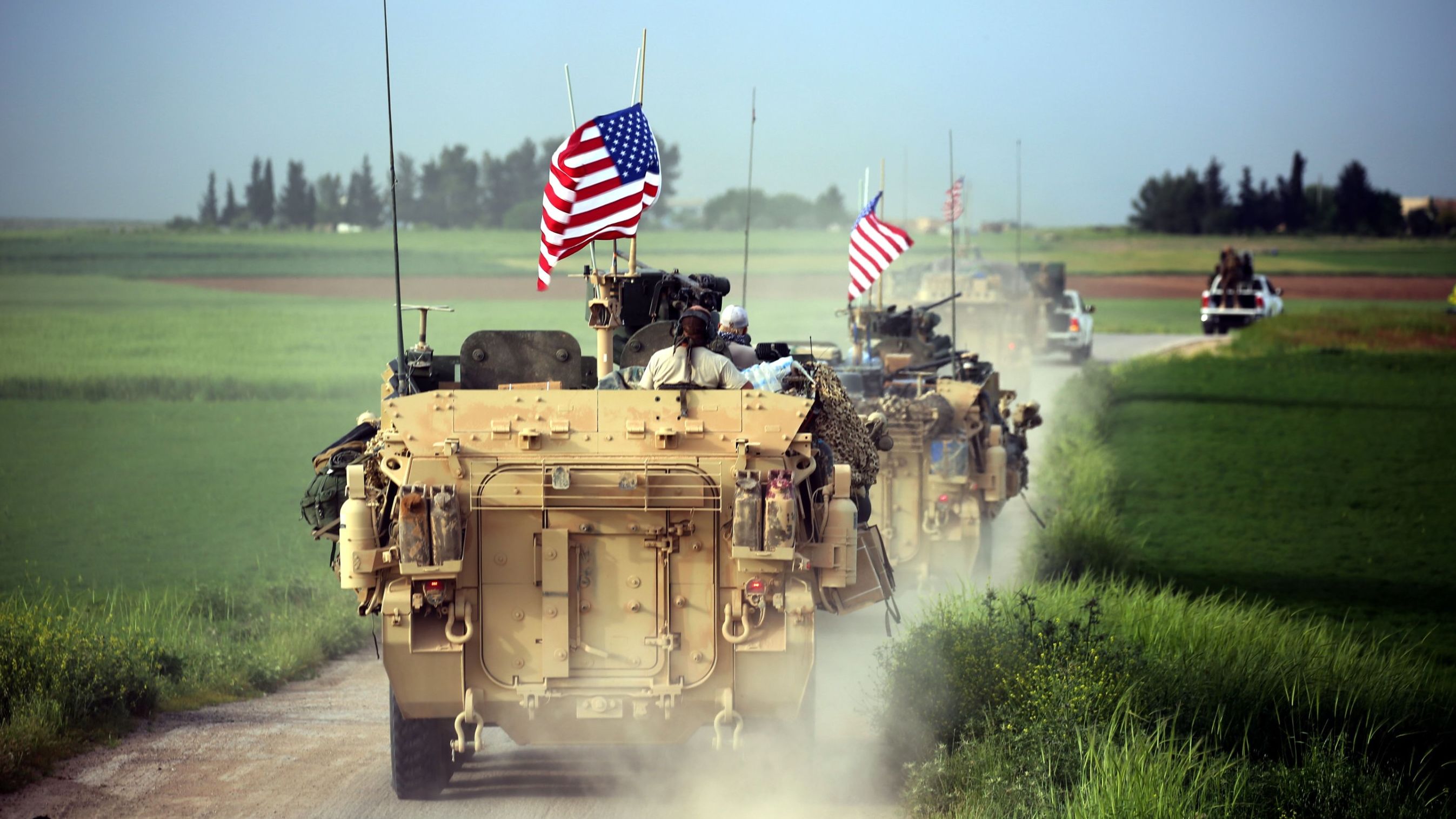US forces accompanied by Kurdish People's Protection Units (YPG) fighters patrol the Syria-Turkey border on Friday.