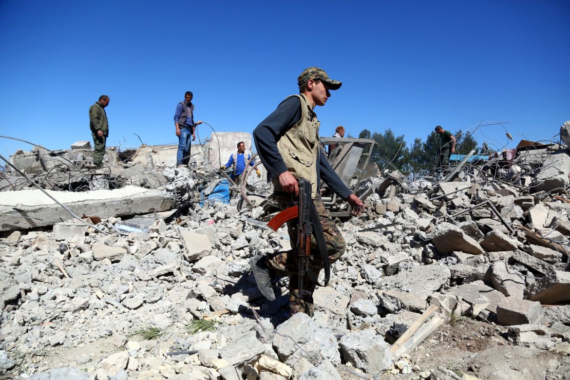 YPG fighters on Wednesday visit the site of Turkish airstrikes near the Syrian Kurdish town of Derik.