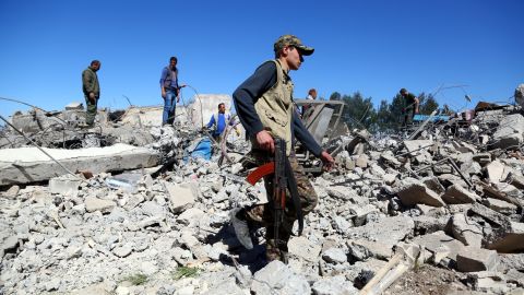 YPG fighters on Wednesday visit the site of Turkish airstrikes near the Syrian Kurdish town of Derik.