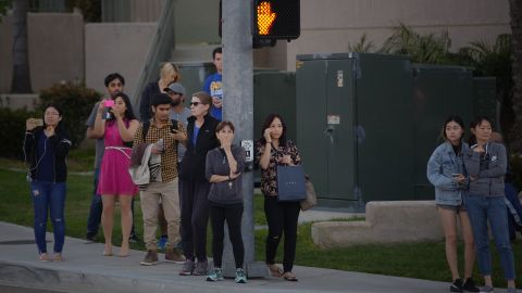 A crowd gathers outside the La Jolla Crossroads apartments in San Diego.