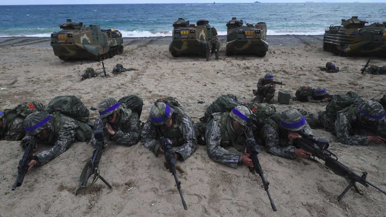 South Korean Marines take position on a beach during a joint landing operation by US and South Korean Marines in the southeastern port of Pohang on April 2, 2017.