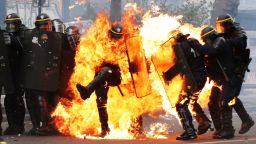TOPSHOT - French CRS anti-riot police officers are engulfed in flames as they face protesters during a march for the annual May Day workers' rally in Paris on May 1, 2017. / AFP PHOTO / Zakaria ABDELKAFI        (Photo credit should read ZAKARIA ABDELKAFI/AFP/Getty Images)